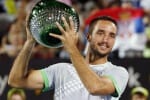 Viktor Troickii of Serbia holds the men’s singles trophy after defeating Mikhail Kukushkin of Kazakhstan at the Sydney International tennis tournament in Sydney