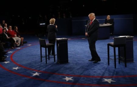 Republican U.S. presidential nominee Donald Trump turns his back as Democratic U.S. presidential nominee Hillary Clinton talks about his comments about women during their presidential town hall debate at Washington University in St. Louis, Missouri, U.S., October 9, 2016.  REUTERS/Jim Bourg