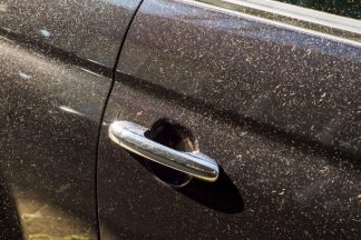 Dust and sand on black car