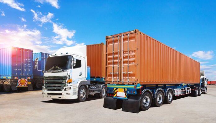 Semi Trailer Trucks on The Parking Lot at The Port. Big Rig, Trucking. Shipping Cargo Container. Import-Export, Economy Business Transport on Road. Freight Transportation, Logistics Truck.